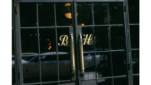 Dark window panes with glowing gold lettering visible through the glass.