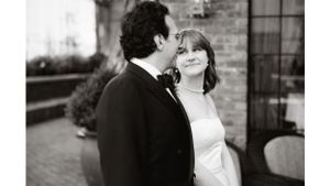 Intimate black and white portrait of a couple sharing a tender moment at their wedding.