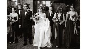 Wedding party in formal attire walking together with bouquets and elegant gowns.