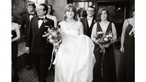 Wedding processional with bridesmaids in dark gowns and a bride in flowing white dress.