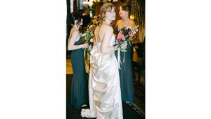 Wedding party members in teal dresses standing together during celebration.