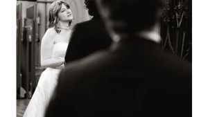 Black and white artistic shot of bride during wedding ceremony.