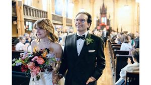 Couple during wedding ceremony in ornate church interior.