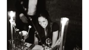 Candlelit table setting at an elegant evening reception.