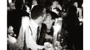 Romantic black and white photo of a couple sharing an intimate moment at an evening gathering.