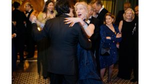 Couples dancing at an elegant evening reception with guests in formal attire.