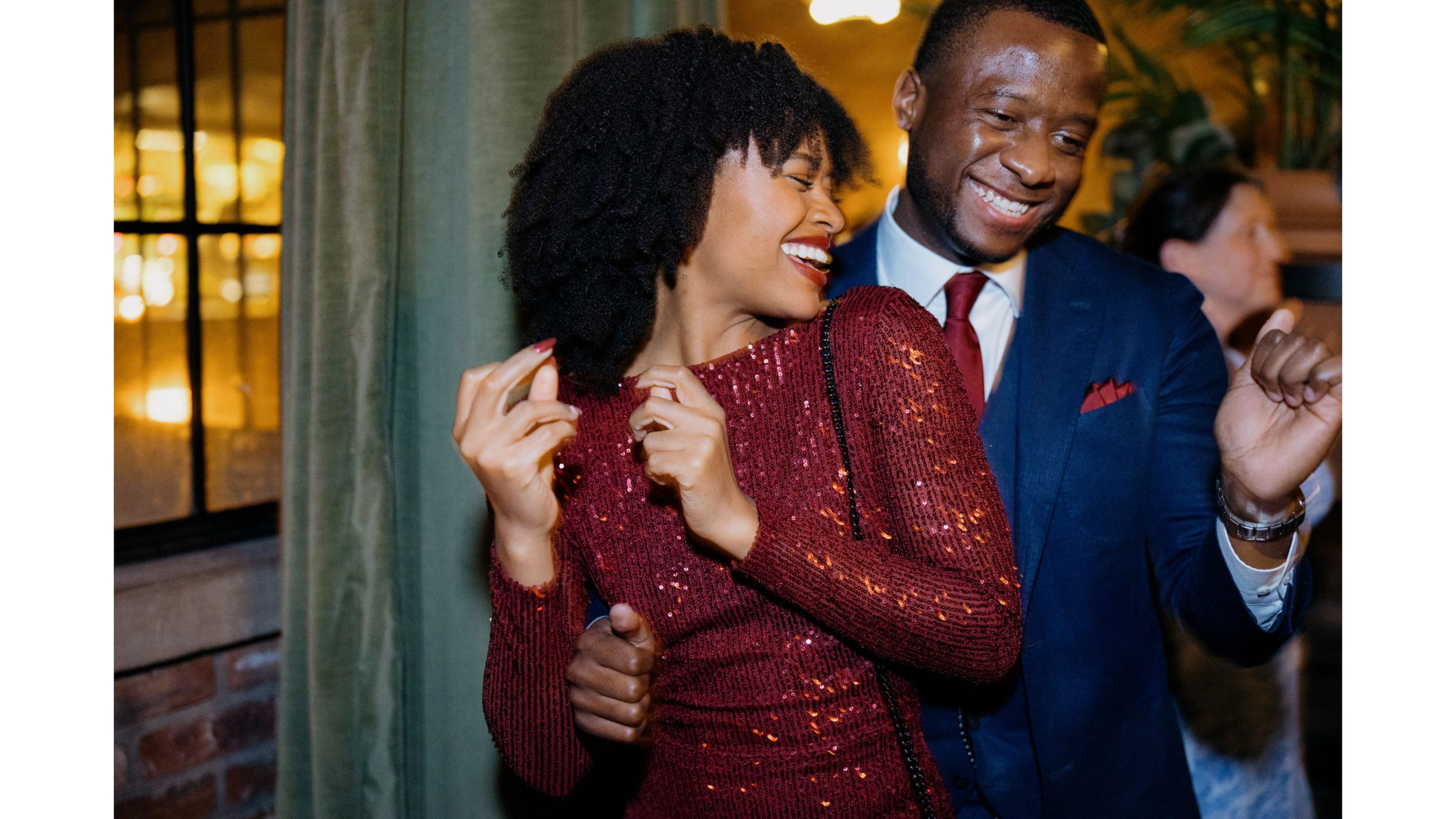 Guests dancing and celebrating at an elegant party in sparkly formal attire.