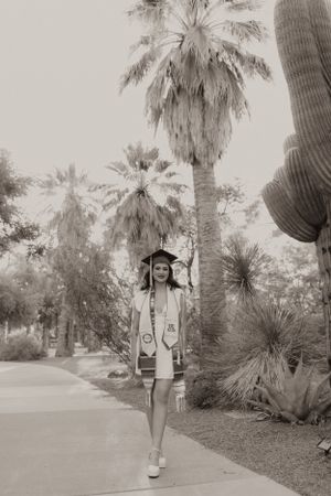 Black and white graduation photos among palm trees and desert plants.