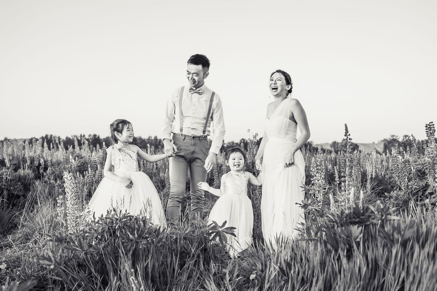 Black and white candid photo of family laughing.