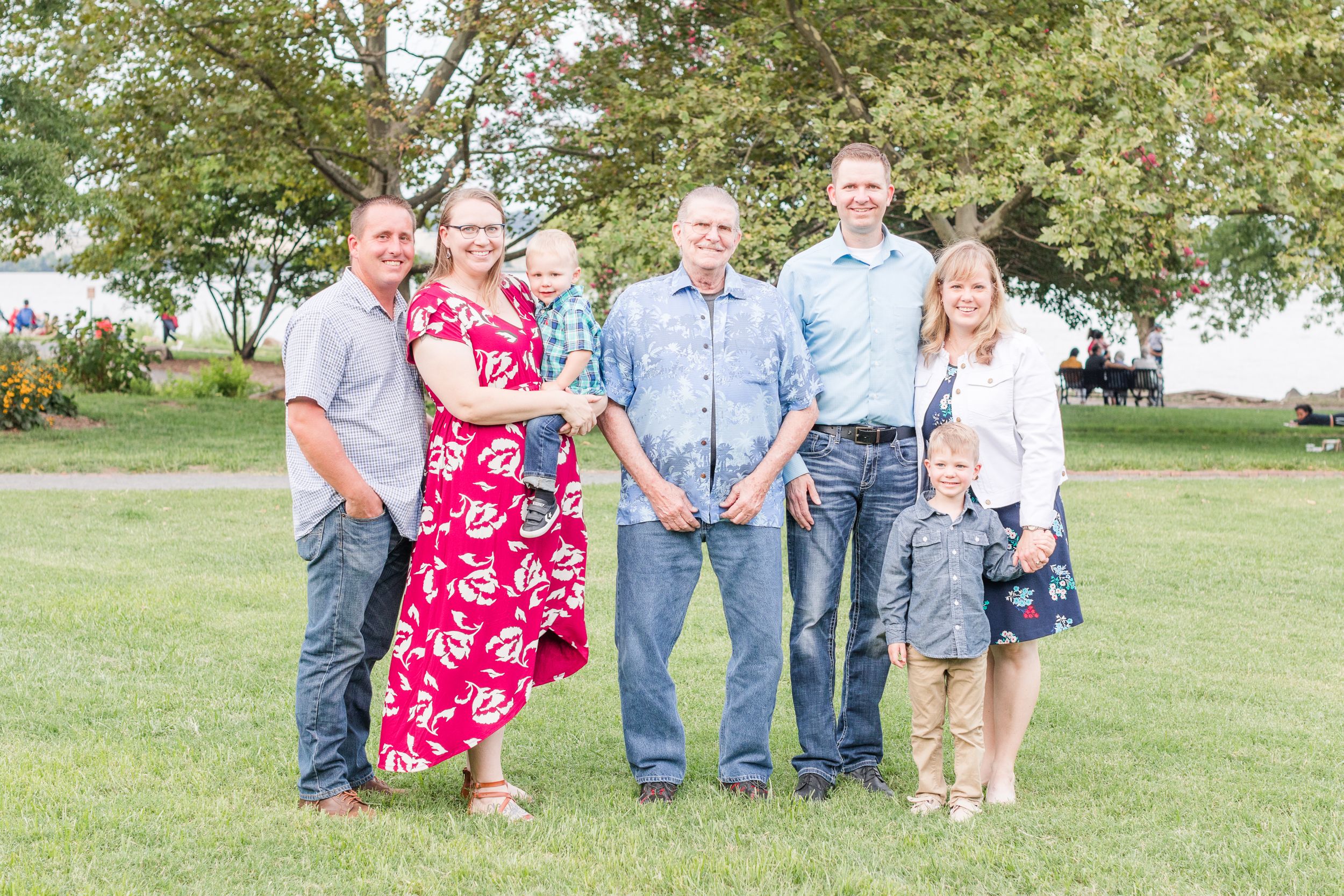 Extended family posing in Founders Park in Old Town Alexandria in summer