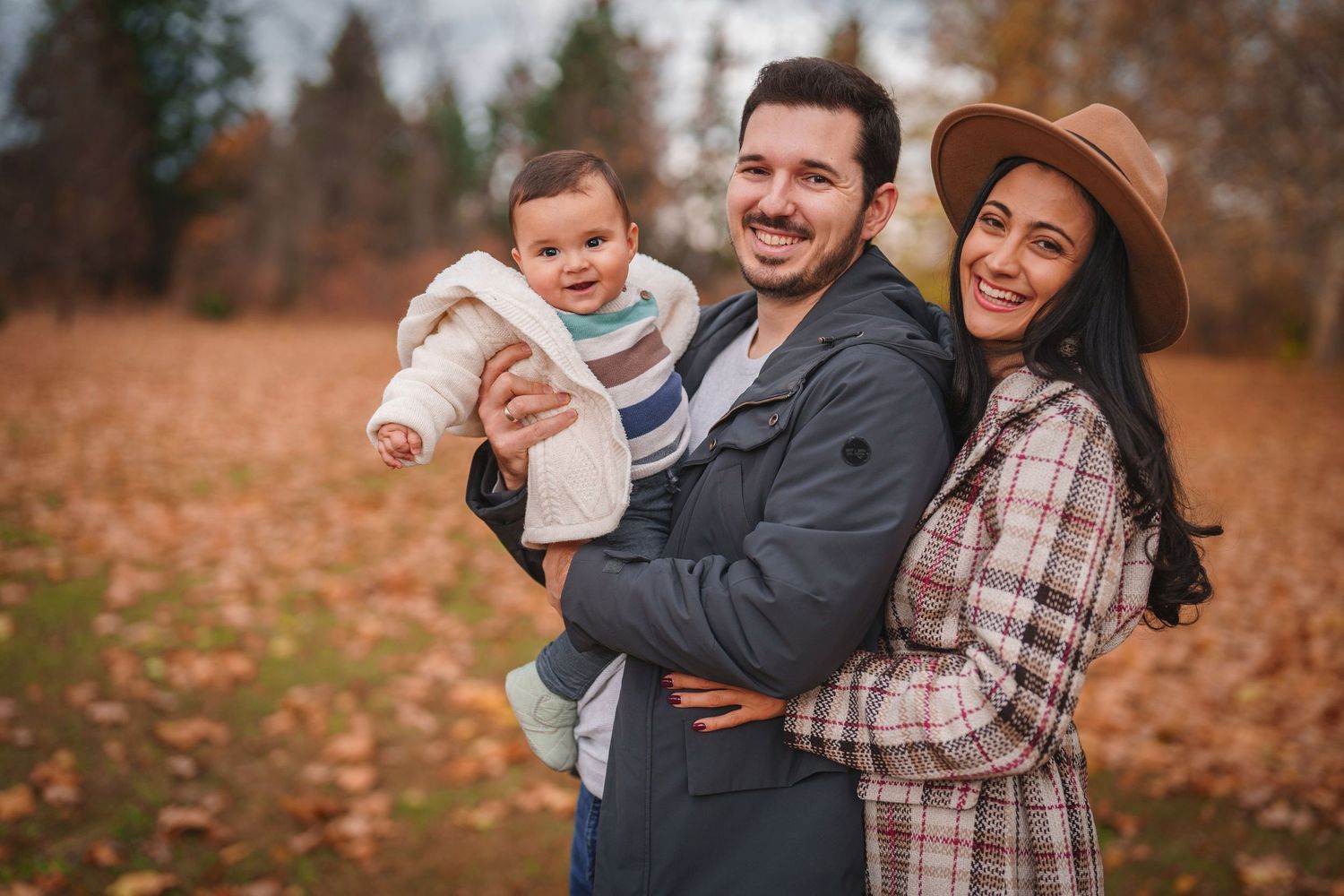 A happy family shares joyful moment together during autumn photo session.