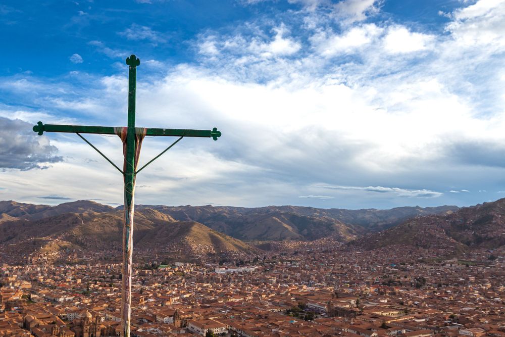 A christian cross overseeing all of Cusco city, Peru on a cloudy day