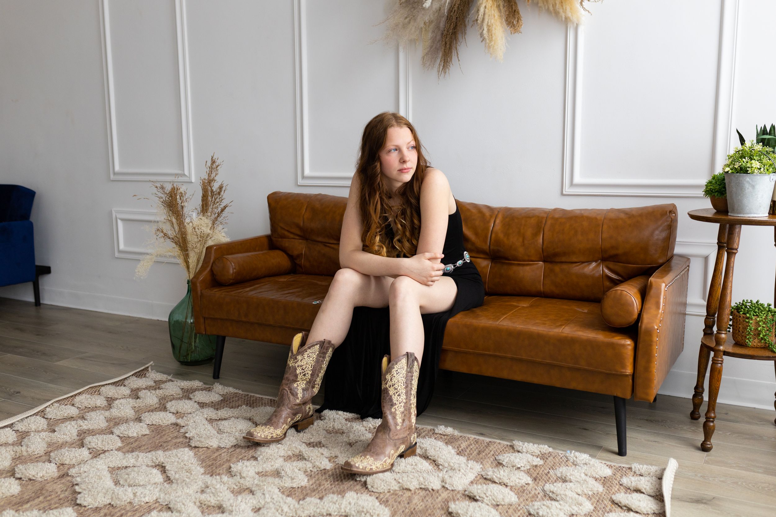 Casual portrait on brown leather sofa with decorative pampas grass and geometric rug.
Janesville, WI
Brodhead, WI