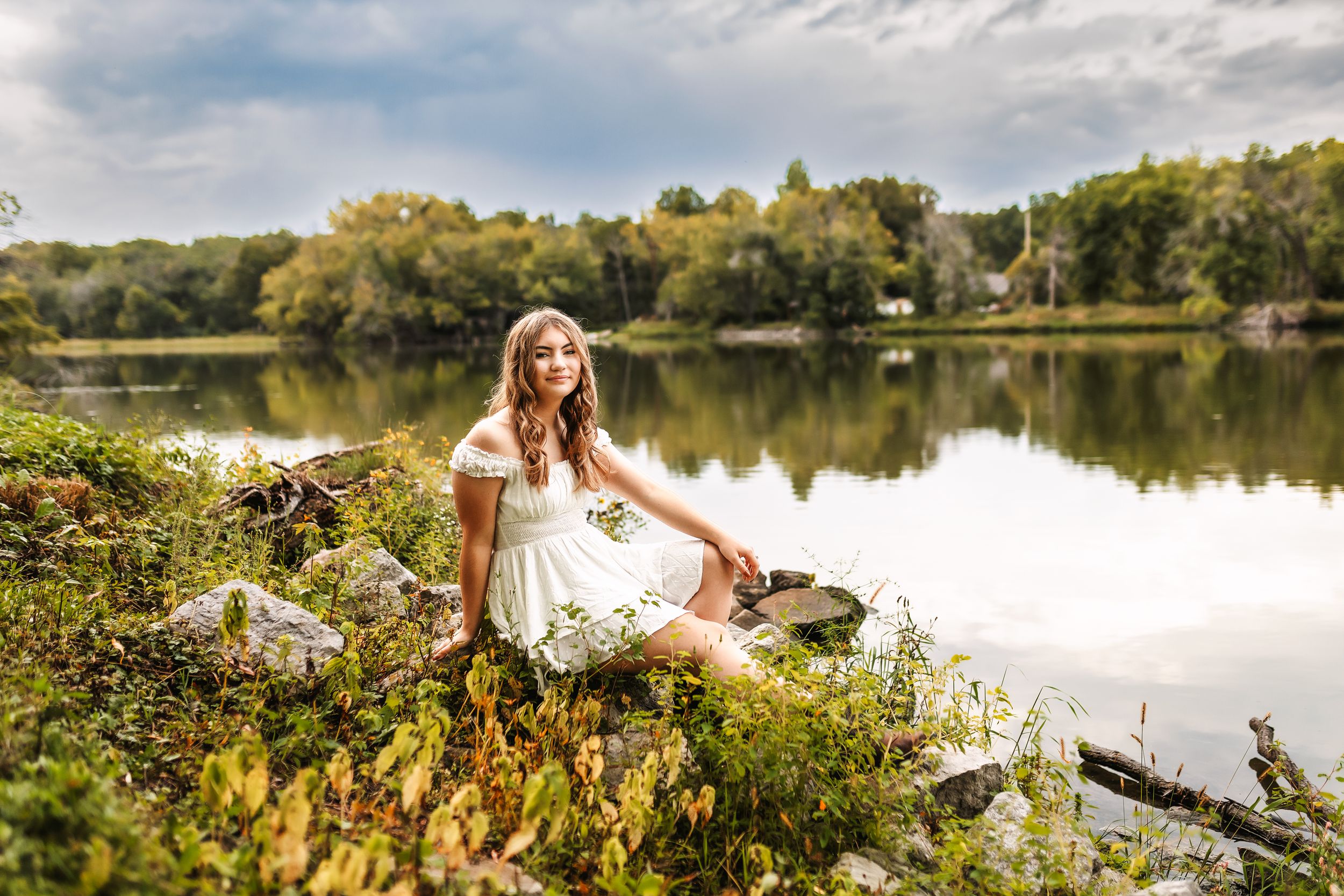 A dreamy outdoor portrait session by a tranquil lake with white wildflowers in the foreground.
Janesville, WI
Brodhead, WI