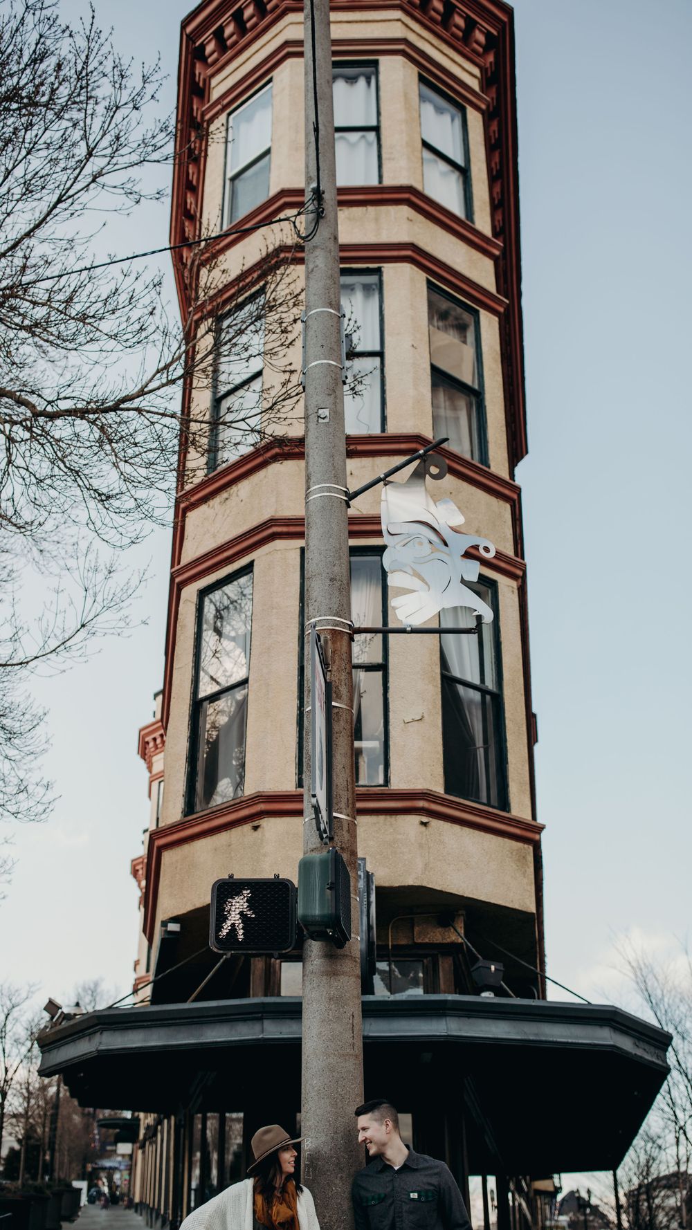 View of a historic Victorian tower building with distinctive bay windows in an urban setting.