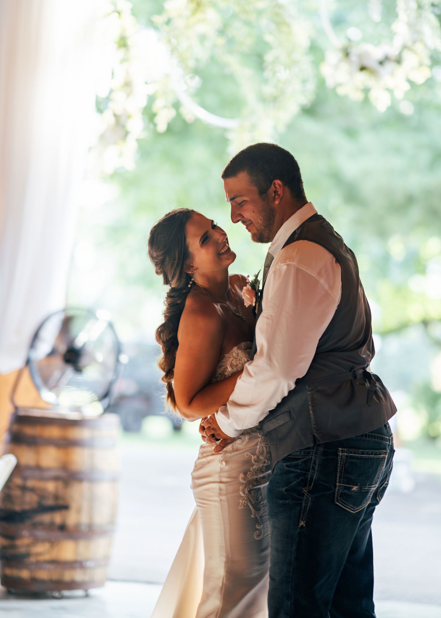 Romantic moment between newlyweds during their rustic-themed wedding reception.