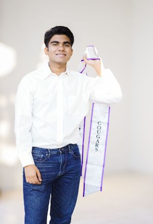 Child in white shirt and jeans poses against white background with purple shopping bag.