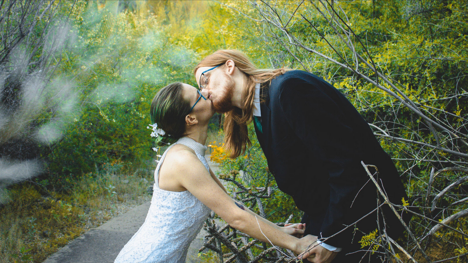 Romantic outdoor photo session in a dreamy forest setting with green and yellow tones.