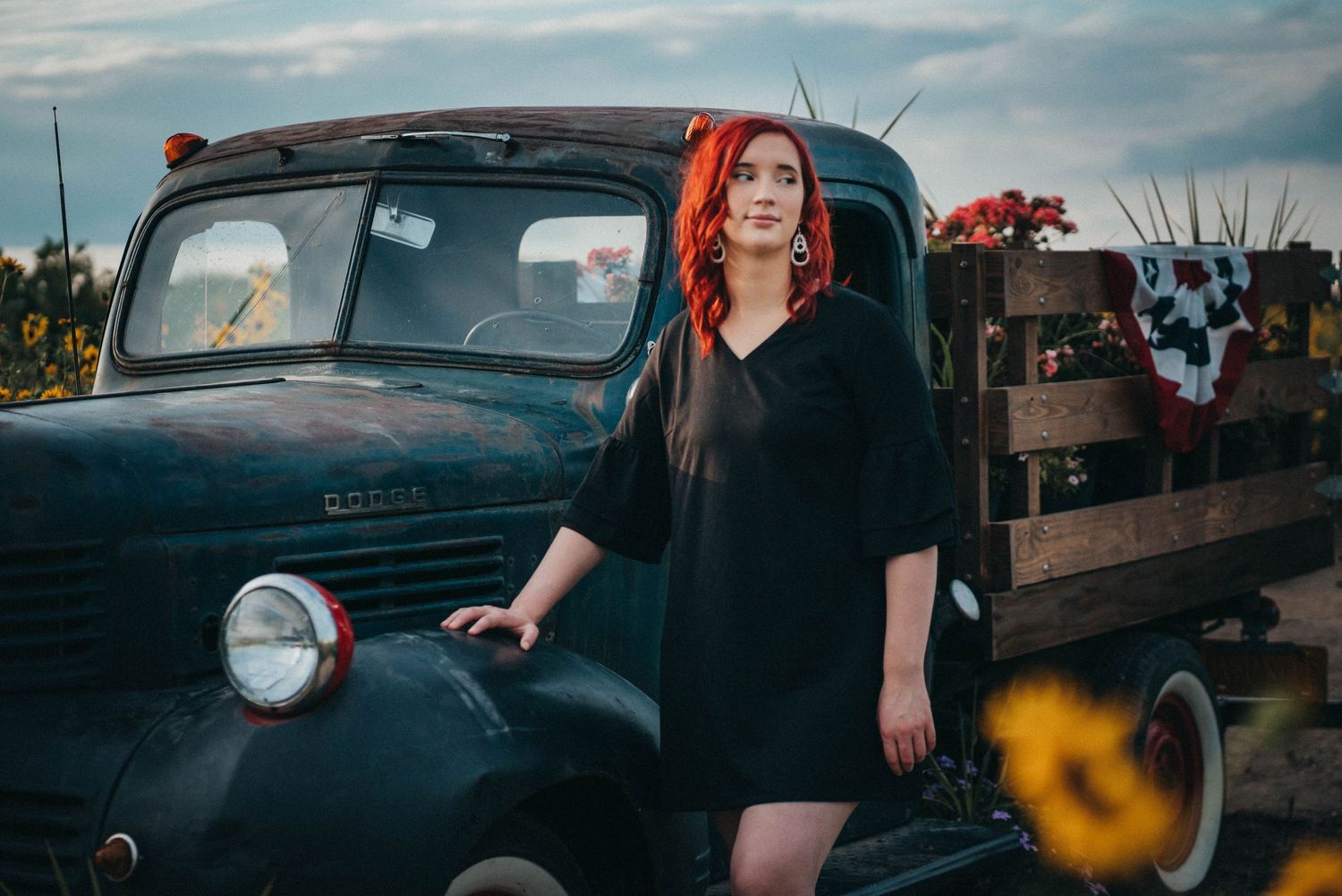 woman standing beside truck