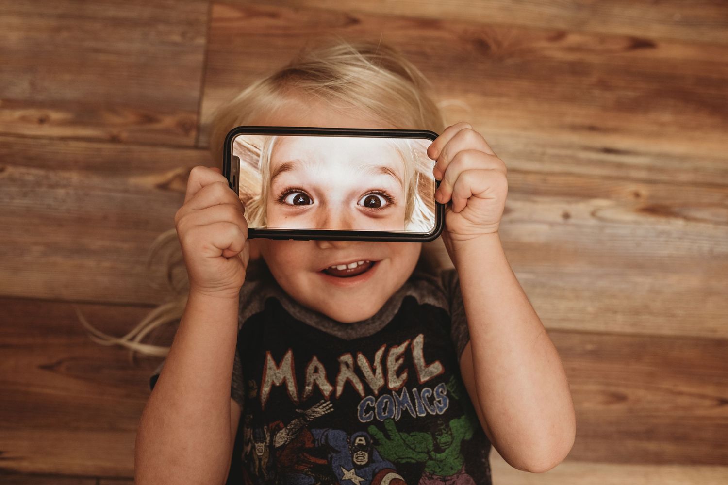 Lakeland Family Photographer- Little boy with phone on his face
