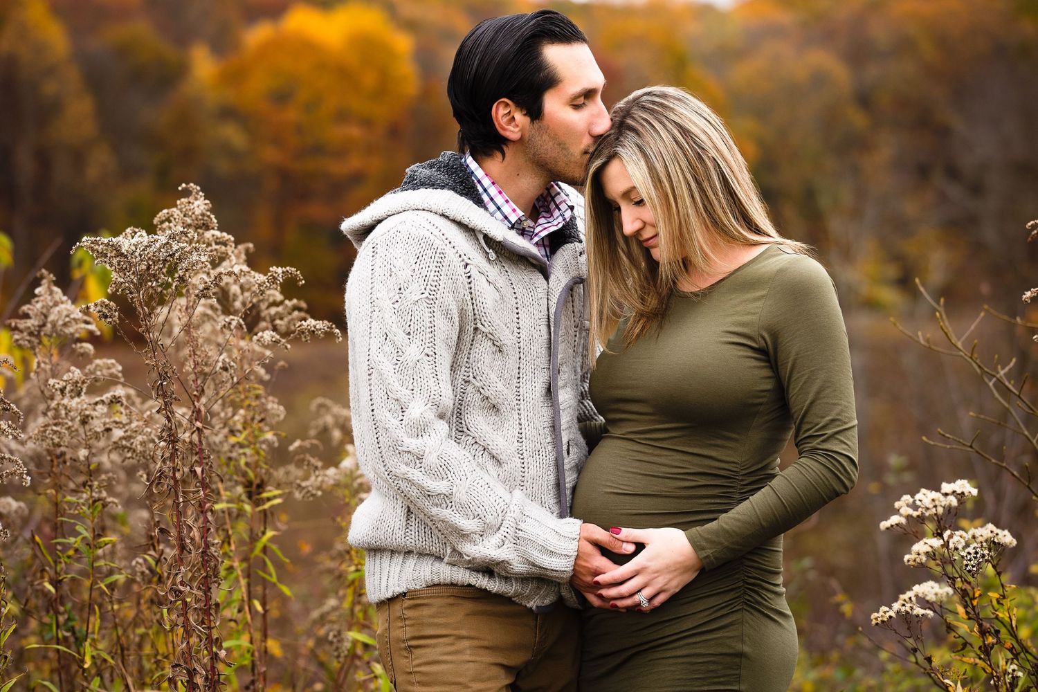 maternity couple embrace baby bump