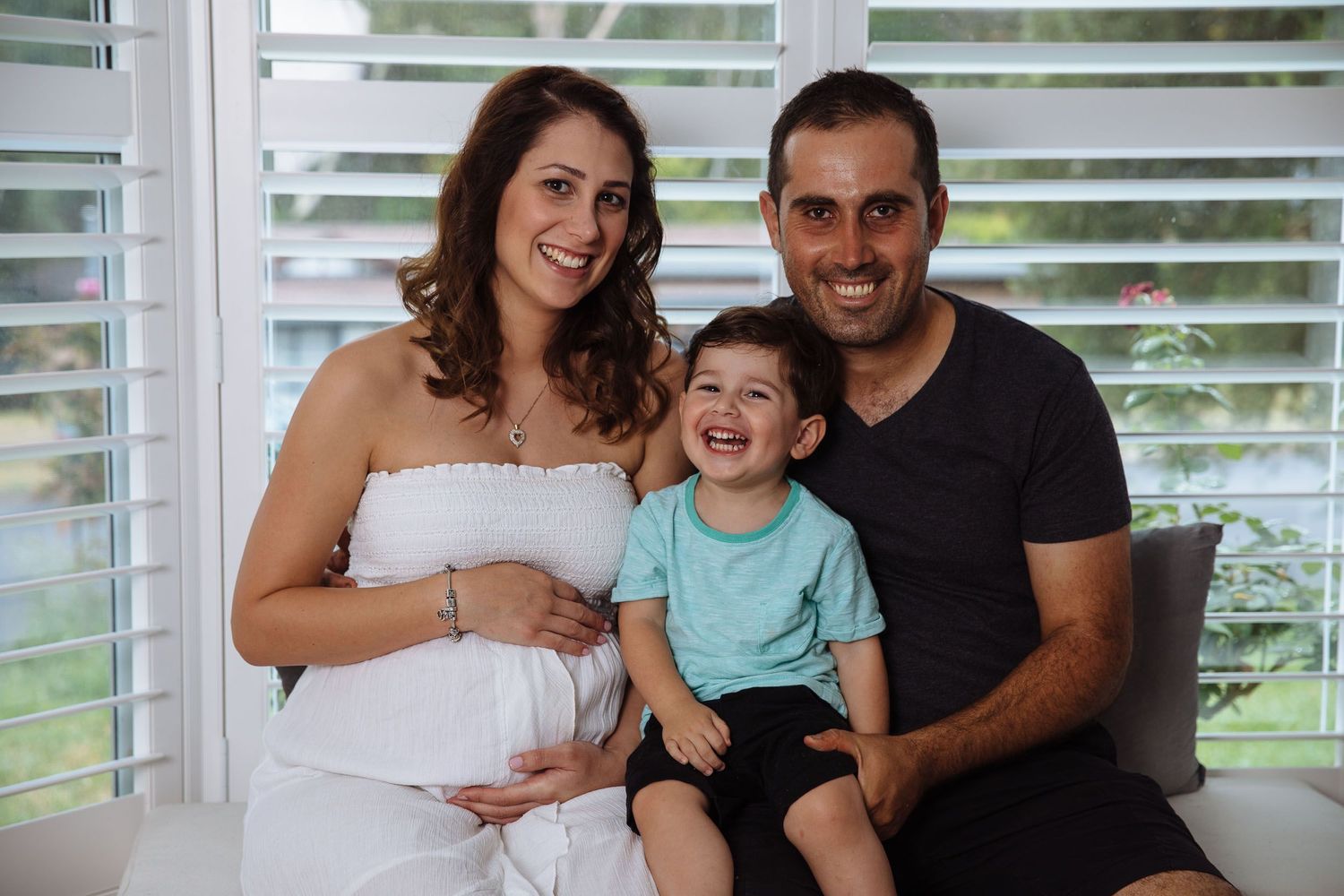 Maternity photo of family with toddler