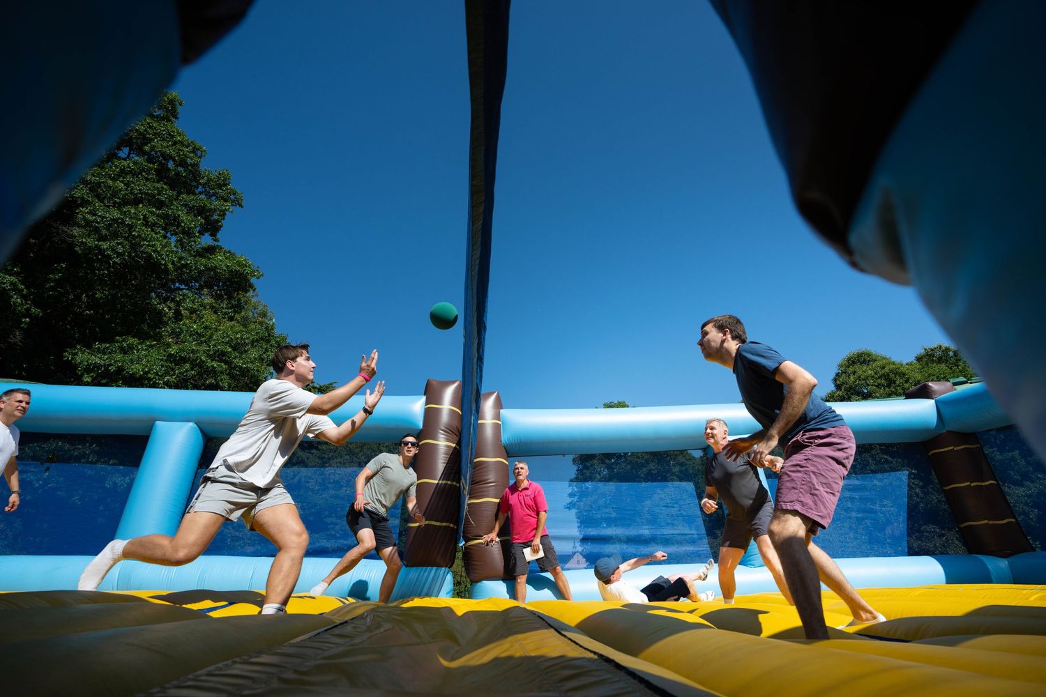 Corporate team building sports day on an inflatable at Pennyhill Park, Corporate Event Photography London