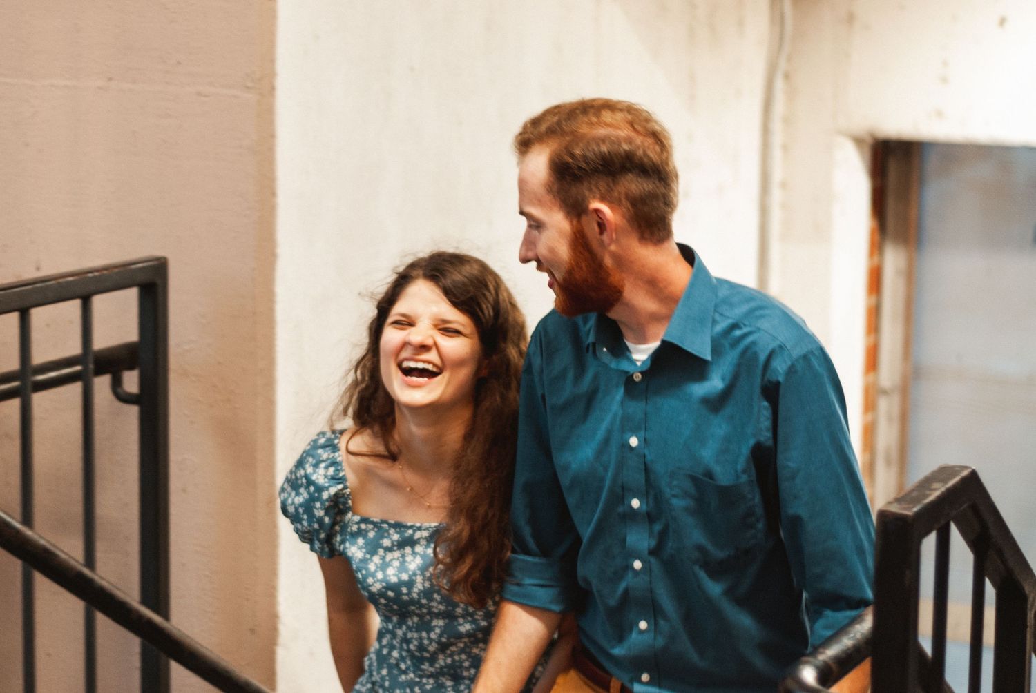 Couple laughing as they climb stairs in parking garage in downtown Greenville, South Carolina