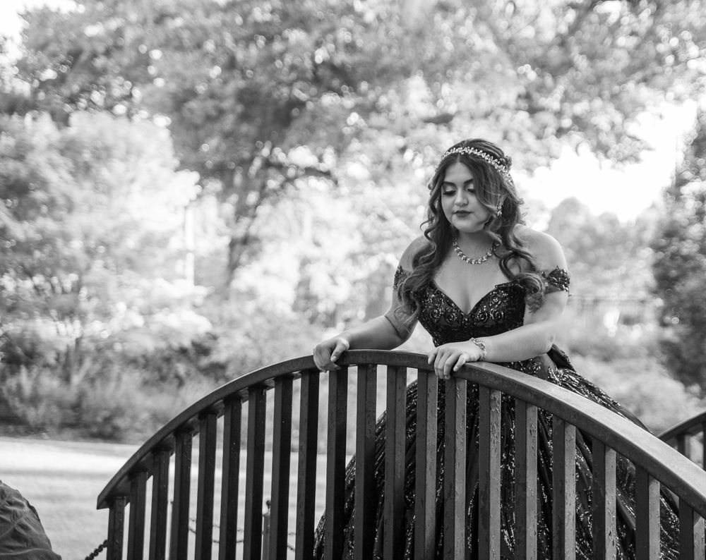 A series of black and white photos showing someone posing on a wooden bench in an outdoor setting.