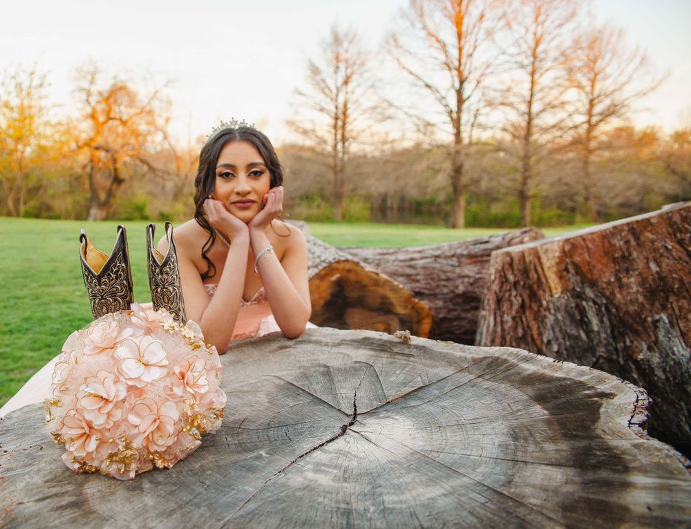 Artistic portrait series on a rustic wooden log during golden hour.
