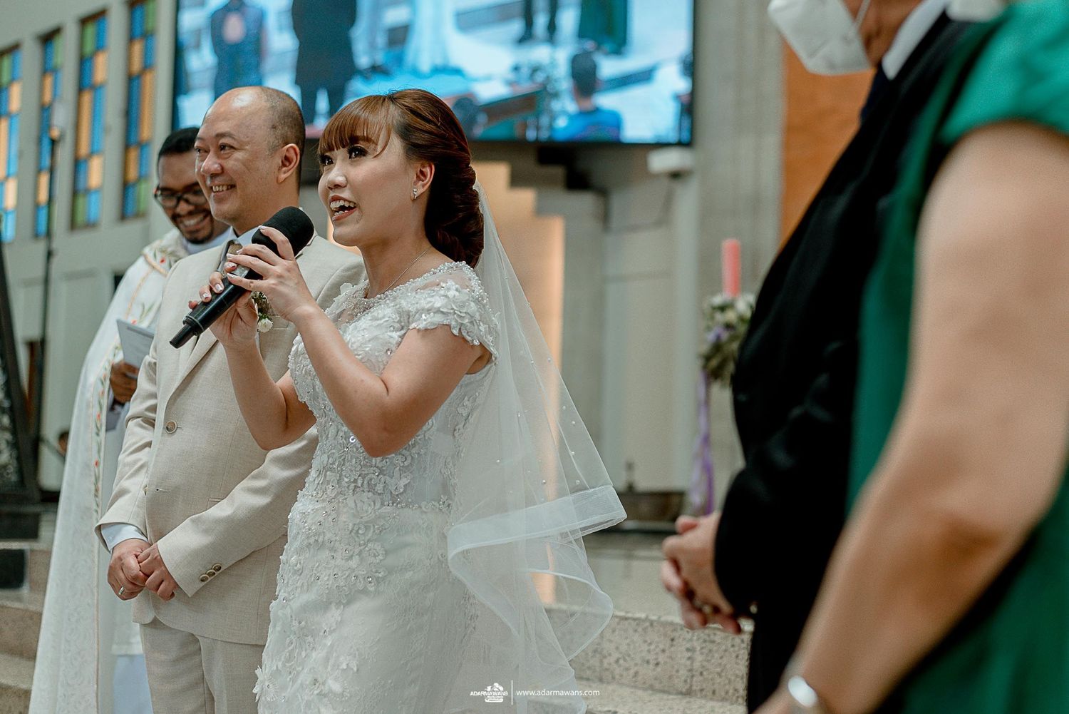 Wedding couple singing together with microphones during their reception celebration.