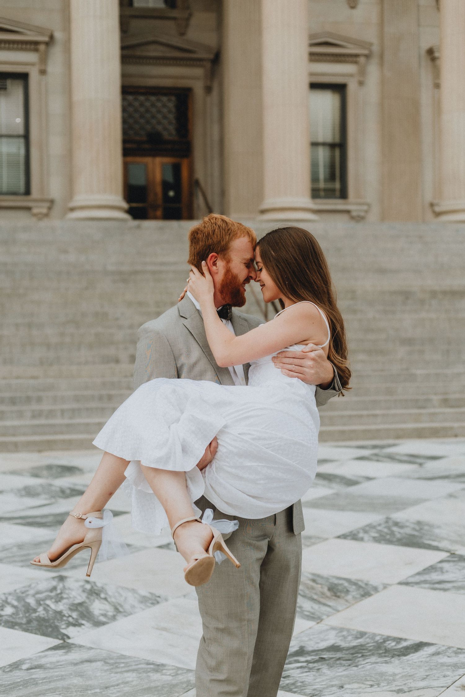 A groom picks up his bride