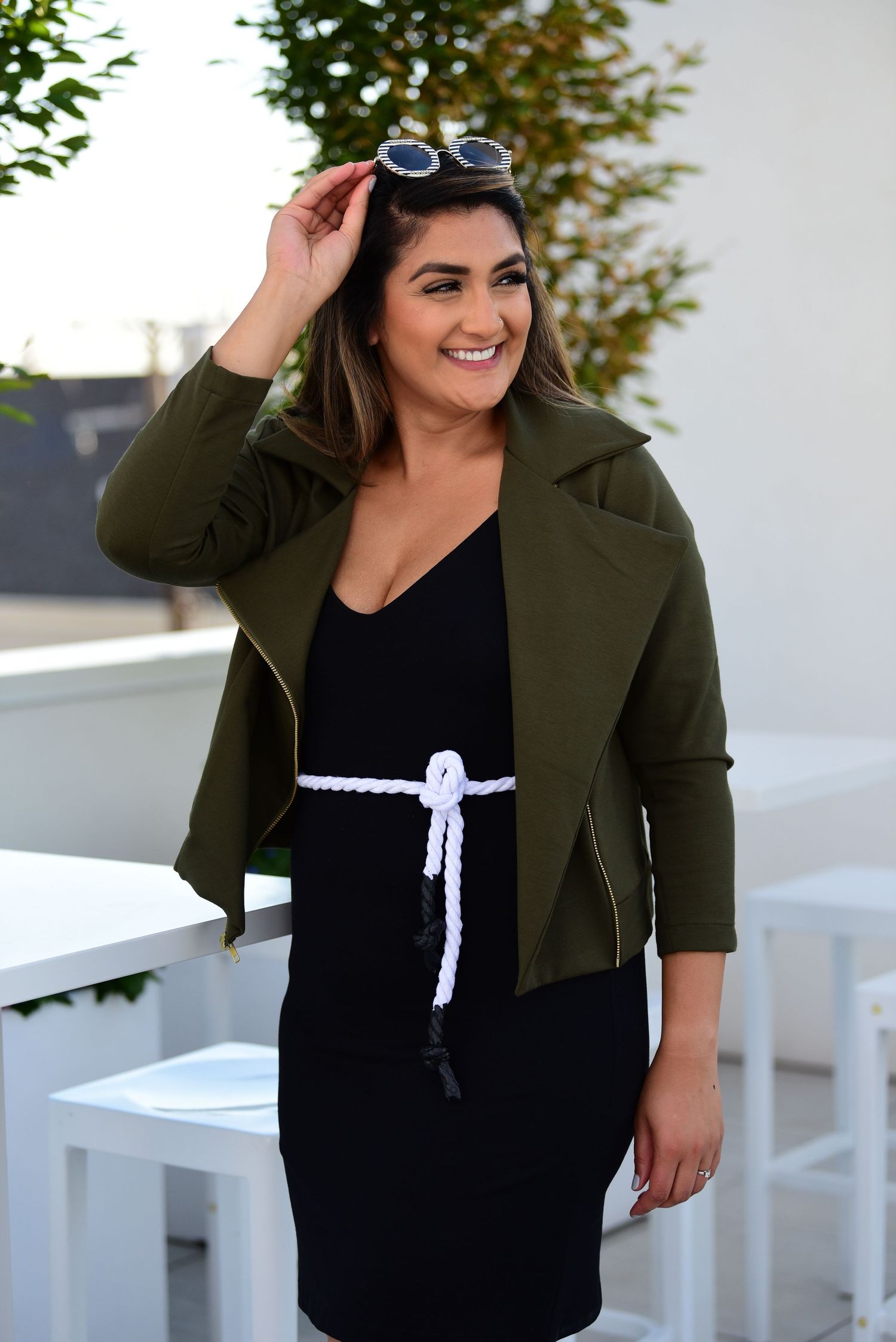 Fashion shots featuring olive green jacket with black and white outfit details.