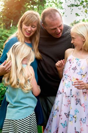 minneapolis family photographer, a family of four smile together outside