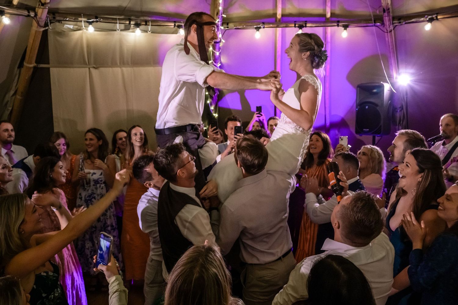 Bride and groom crowd surfing at Coppermines wedding in Lake District