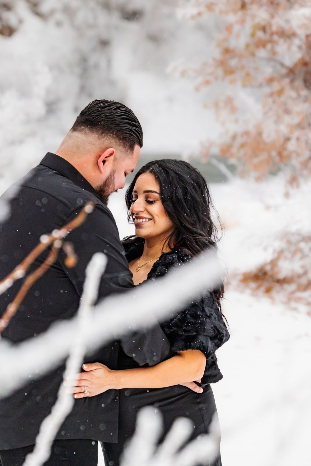 A couple shares joyful moments together during a winter photo session.
