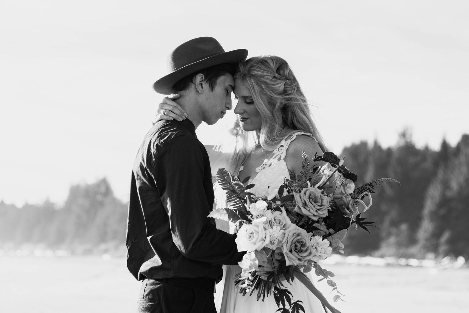 Bride and groom holding bouquet during Tofino, British Columbia Beach Elopement