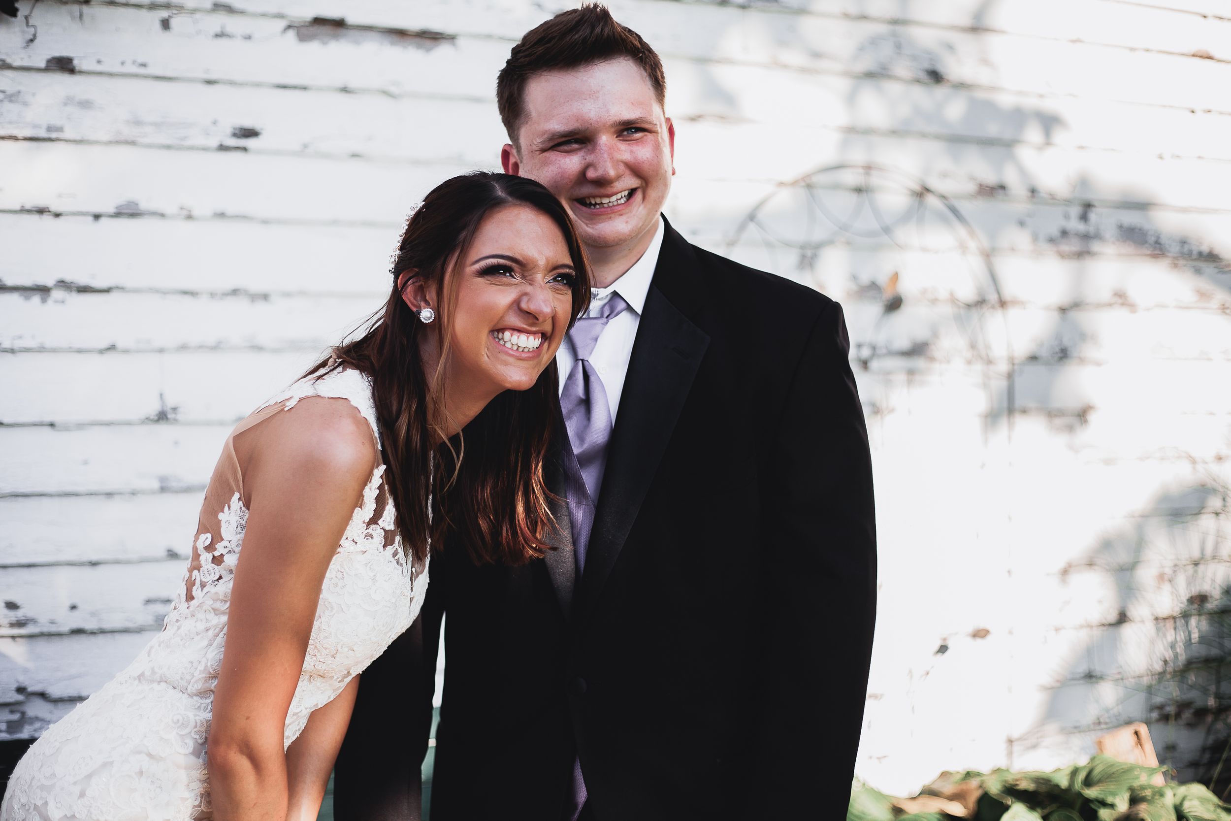bride and groom laugh together