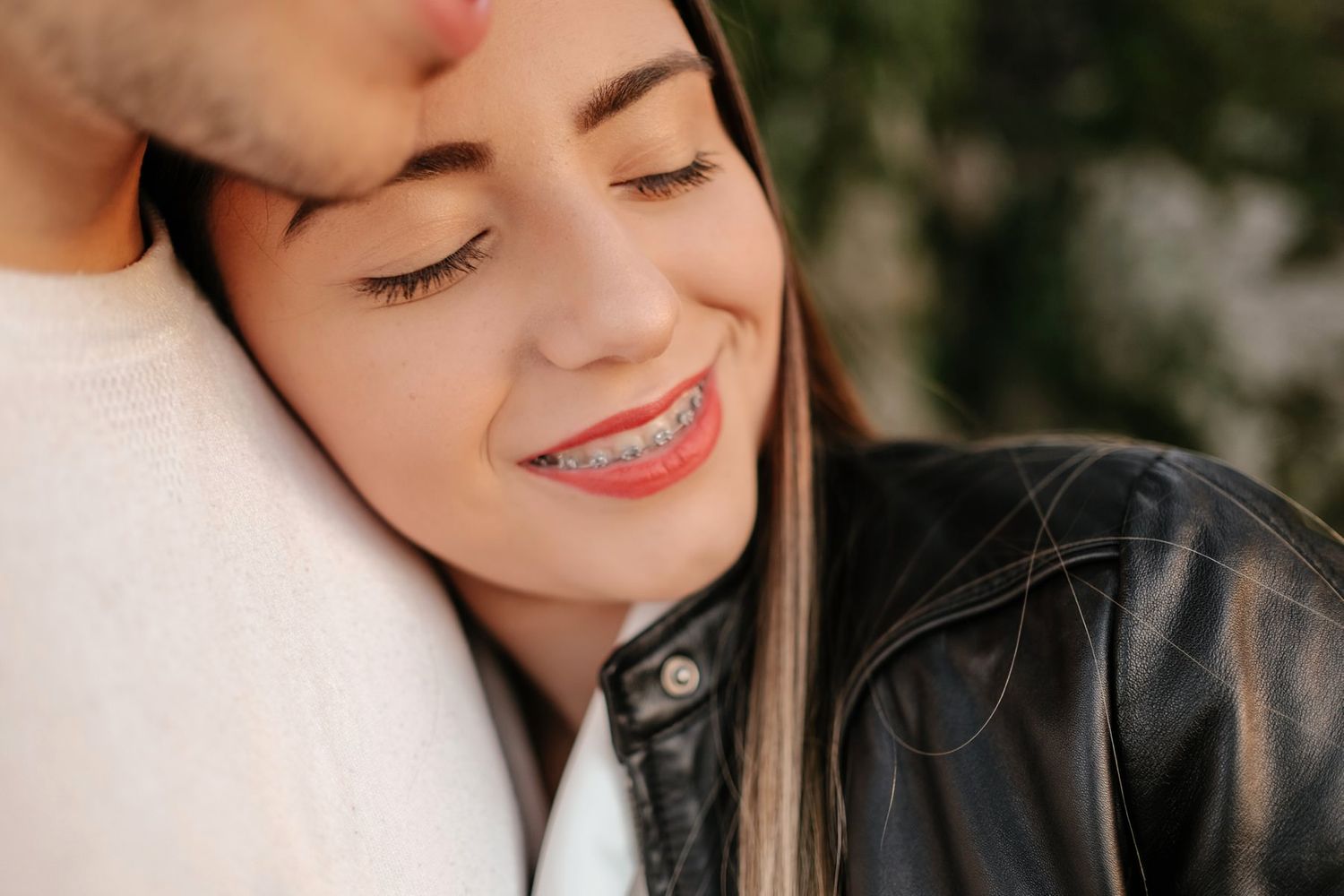 Close-up portrait of a romantic moment showing affection and intimacy outdoors.