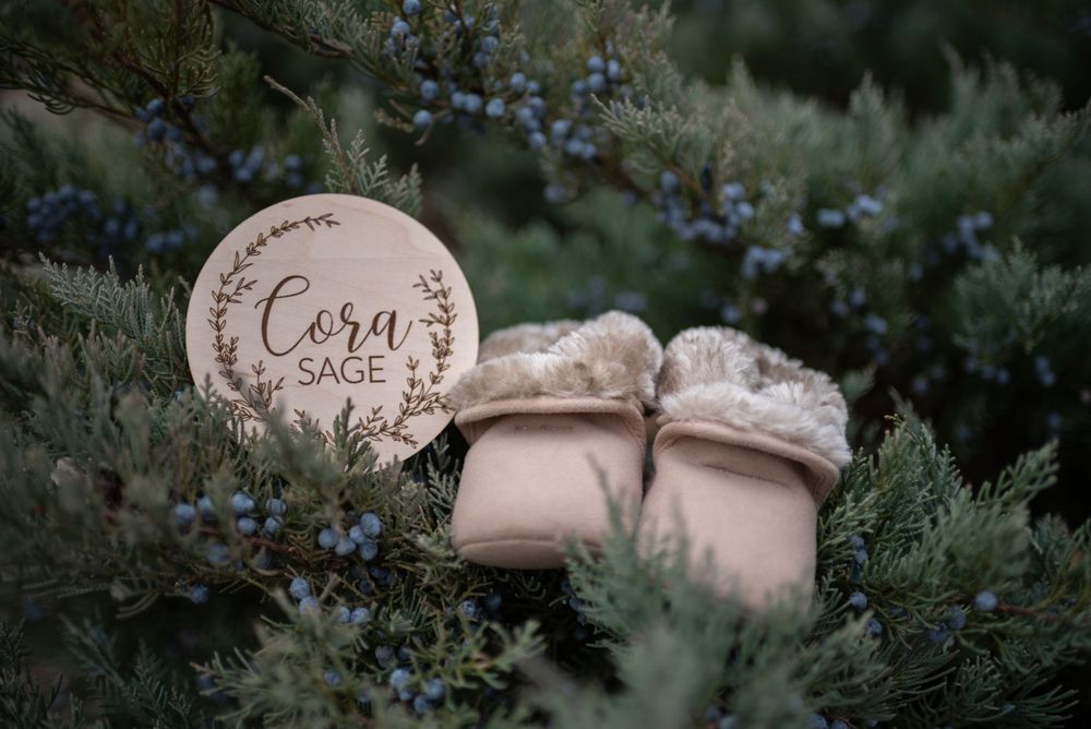 Decorative wooden blocks with cursive lettering in a rustic style display baby's name and age.