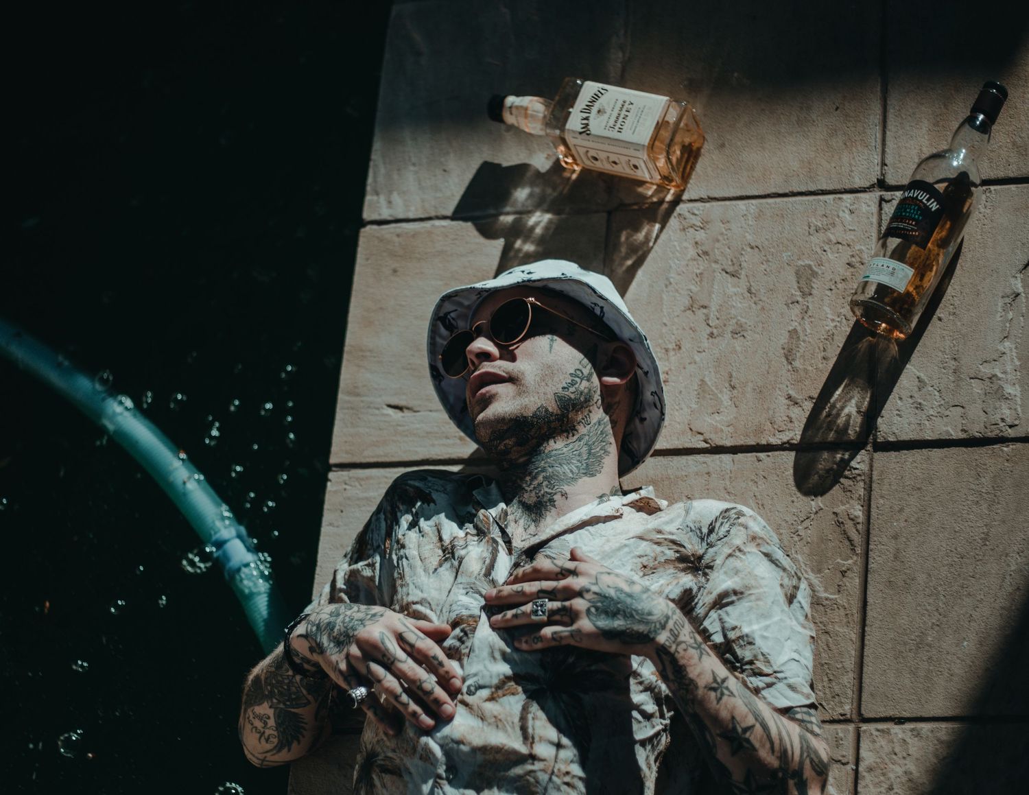 Person spraying colorful smoke in an artistic outdoor photoshoot.
