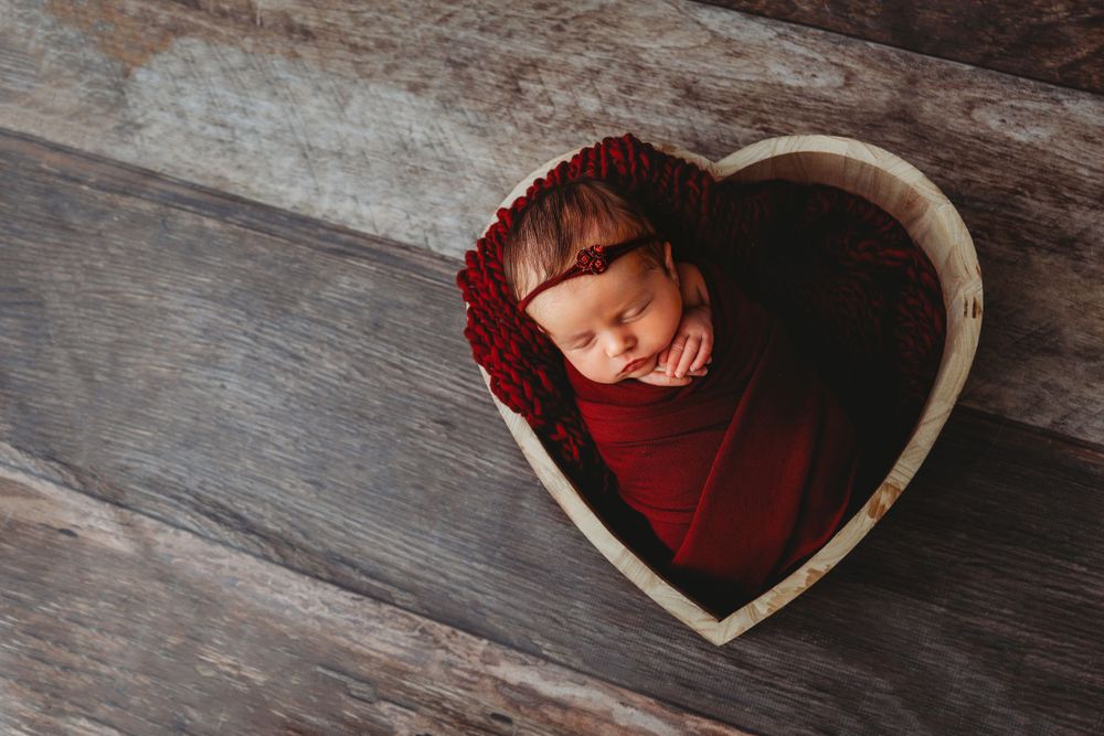 red heart bowl girl newborn posed photographer studio trained skilled professional session local east aurora NY WNY
