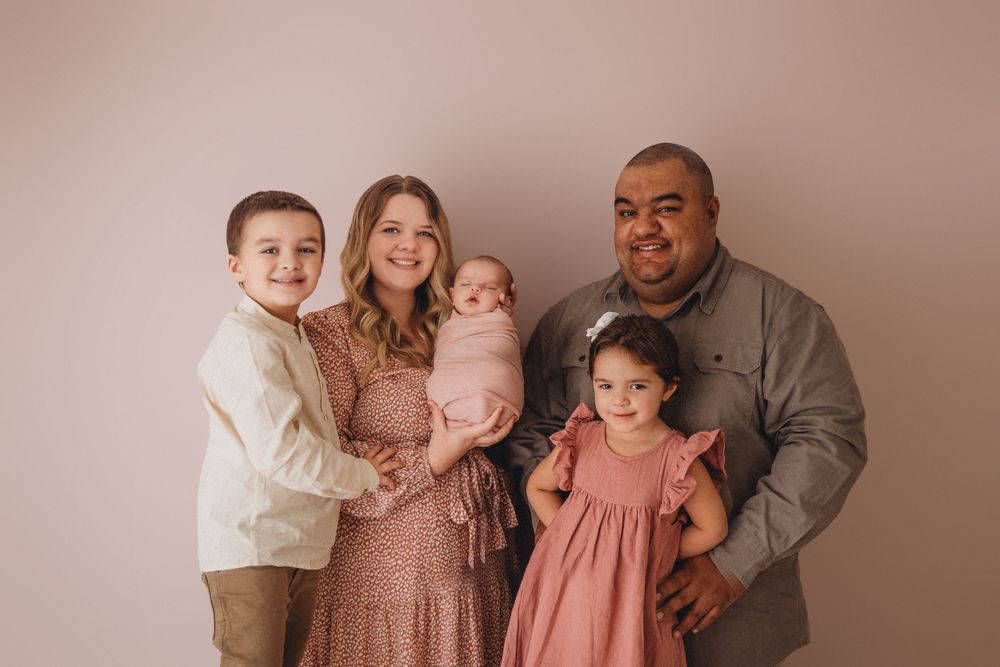 family boy white wrapped newborn posed photographer studio trained skilled professional session local east aurora NY WNY