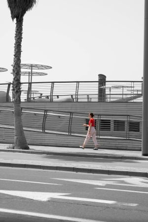 Woman walking in busy road, street photo captured by Michelle Baum Photography