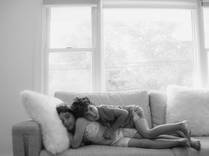 Siblings sit on couch together for lifestyle photoshoot in Deal, NJ captured by Michelle Baum Photography