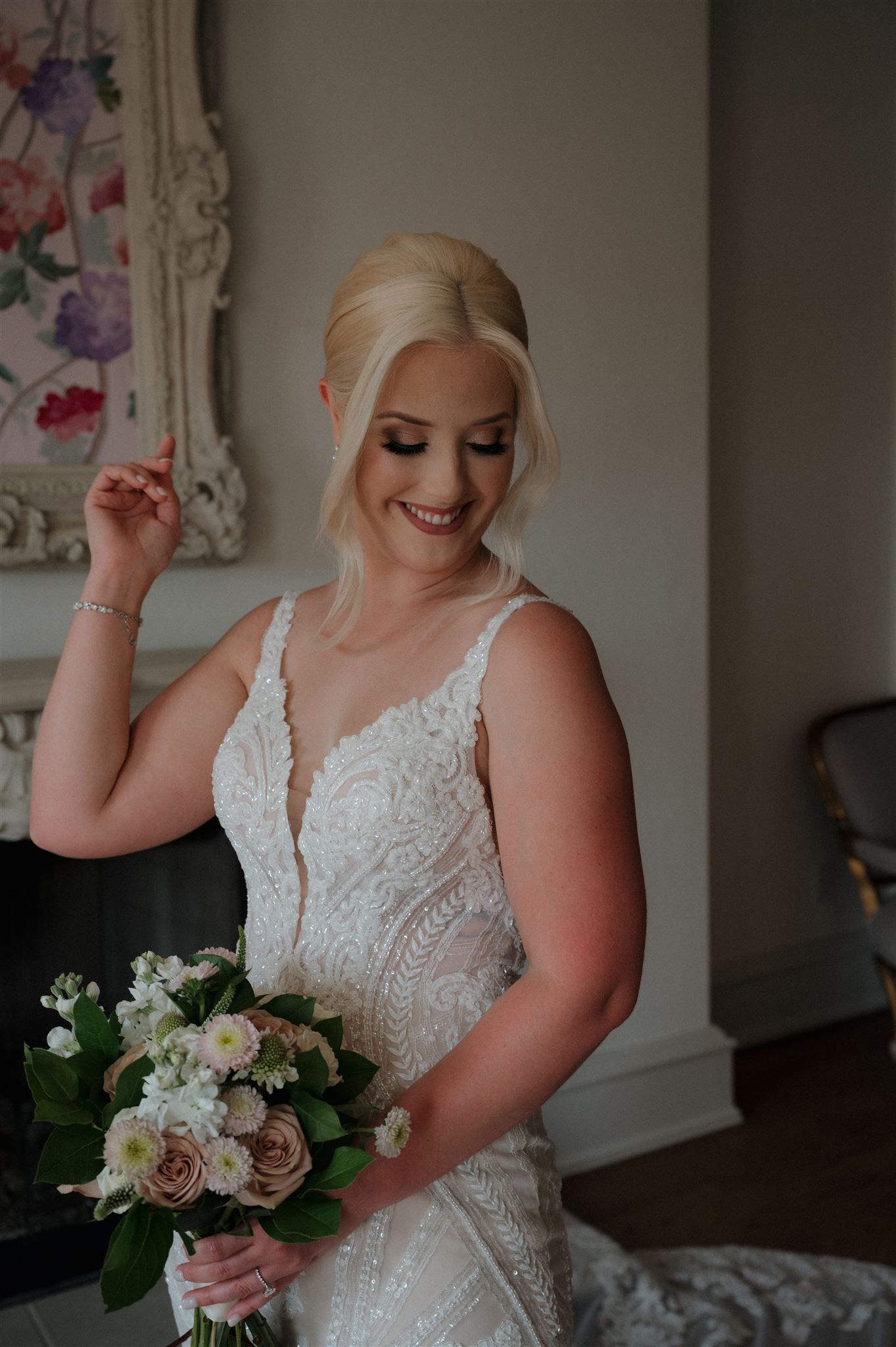 Intimate bridal moment captured with delicate bouquet and detailed lace gown.
