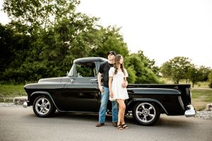 Series of engagement photos with classic black vintage car in outdoor setting.