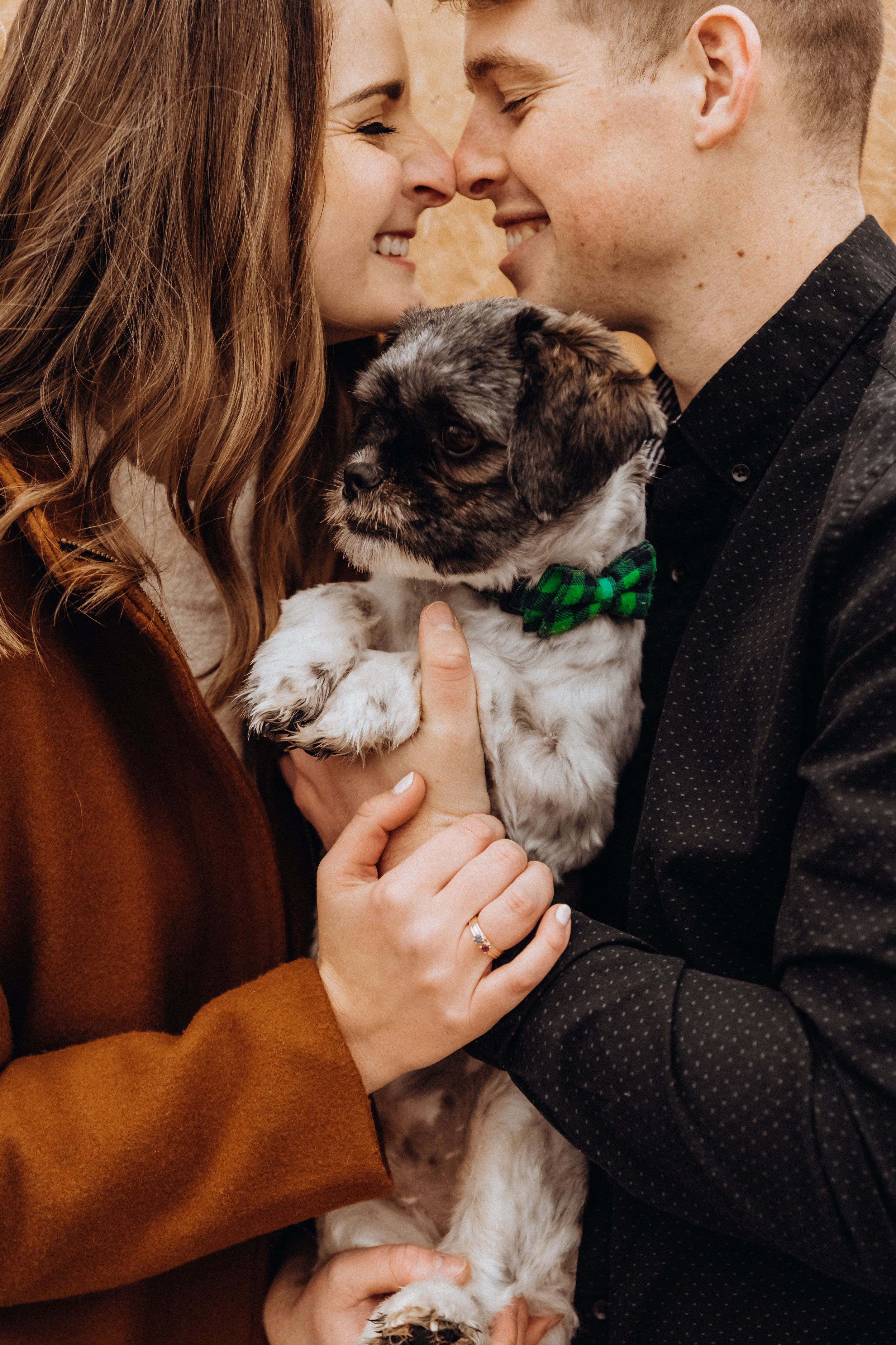 A couple shares tender moments with their small white and gray dog in a series of intimate photos.