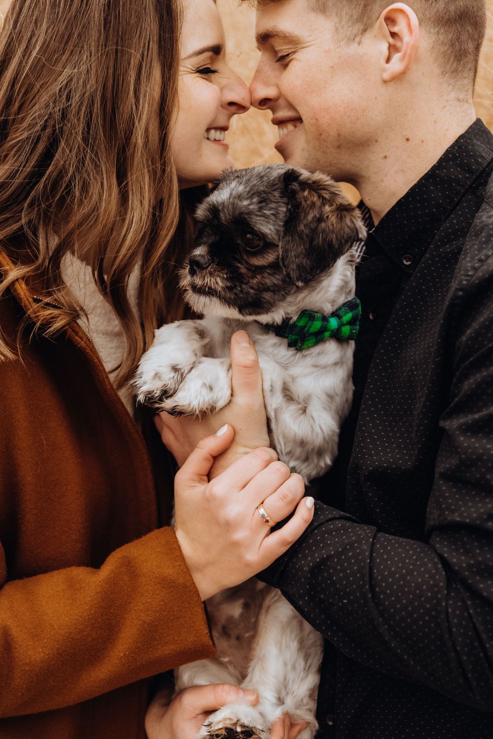 A couple shares tender moments with their small white and gray dog in a series of intimate photos.