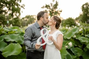 Romantic moments captured in garden setting with lush greenery and natural lighting.